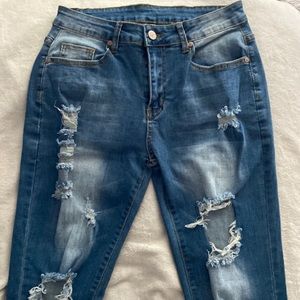 Stone washed distressed blue jeans